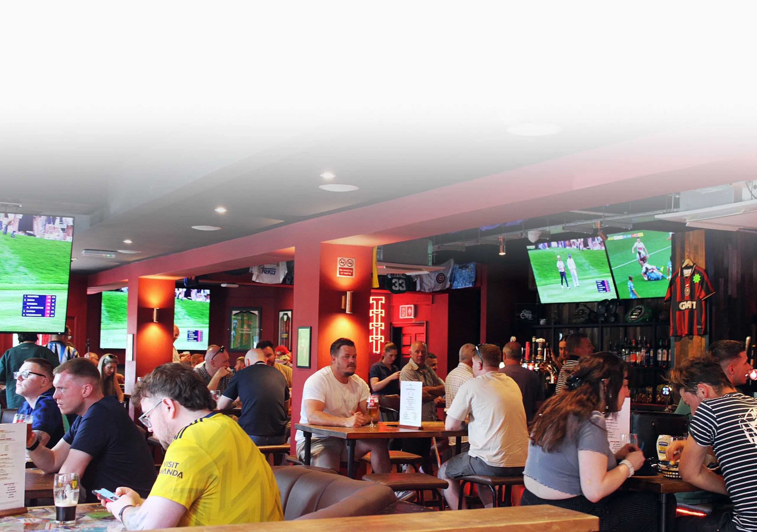 Bull i' th' Thorn Pub two TVs showing an England football game with people watching